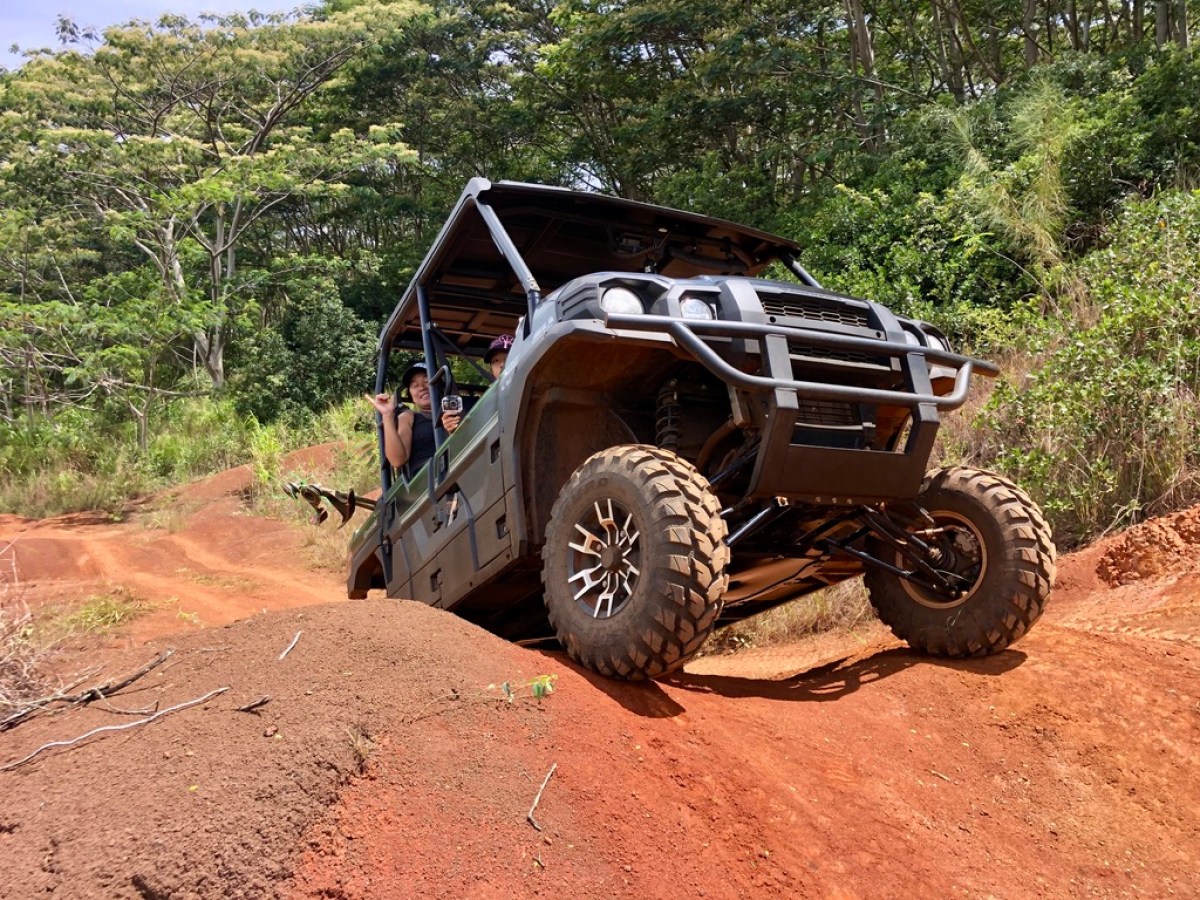 a truck driving down a dirt road