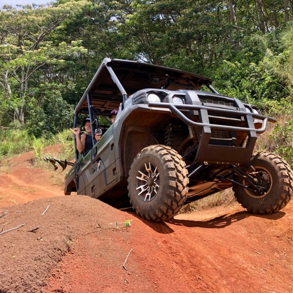 a truck driving down a dirt road