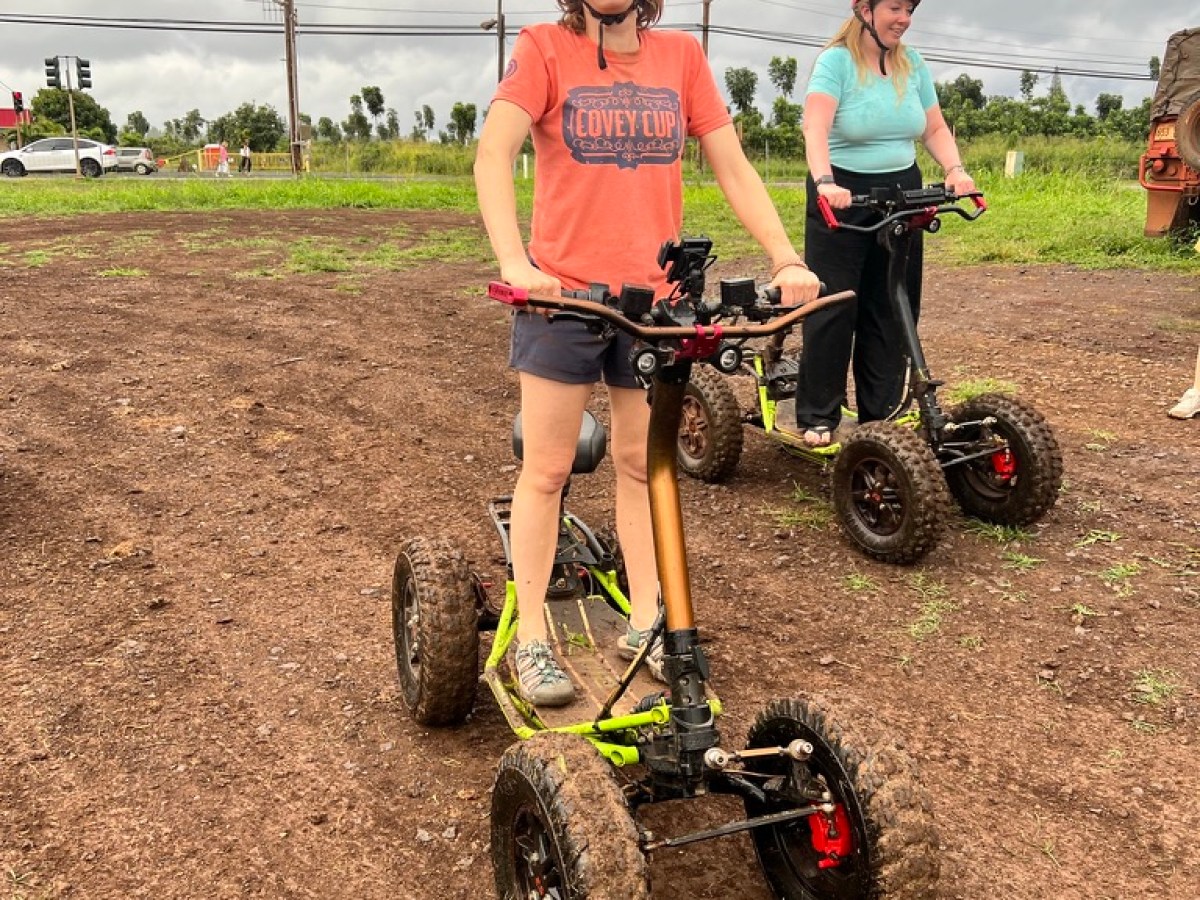a young boy riding a bike down a dirt road