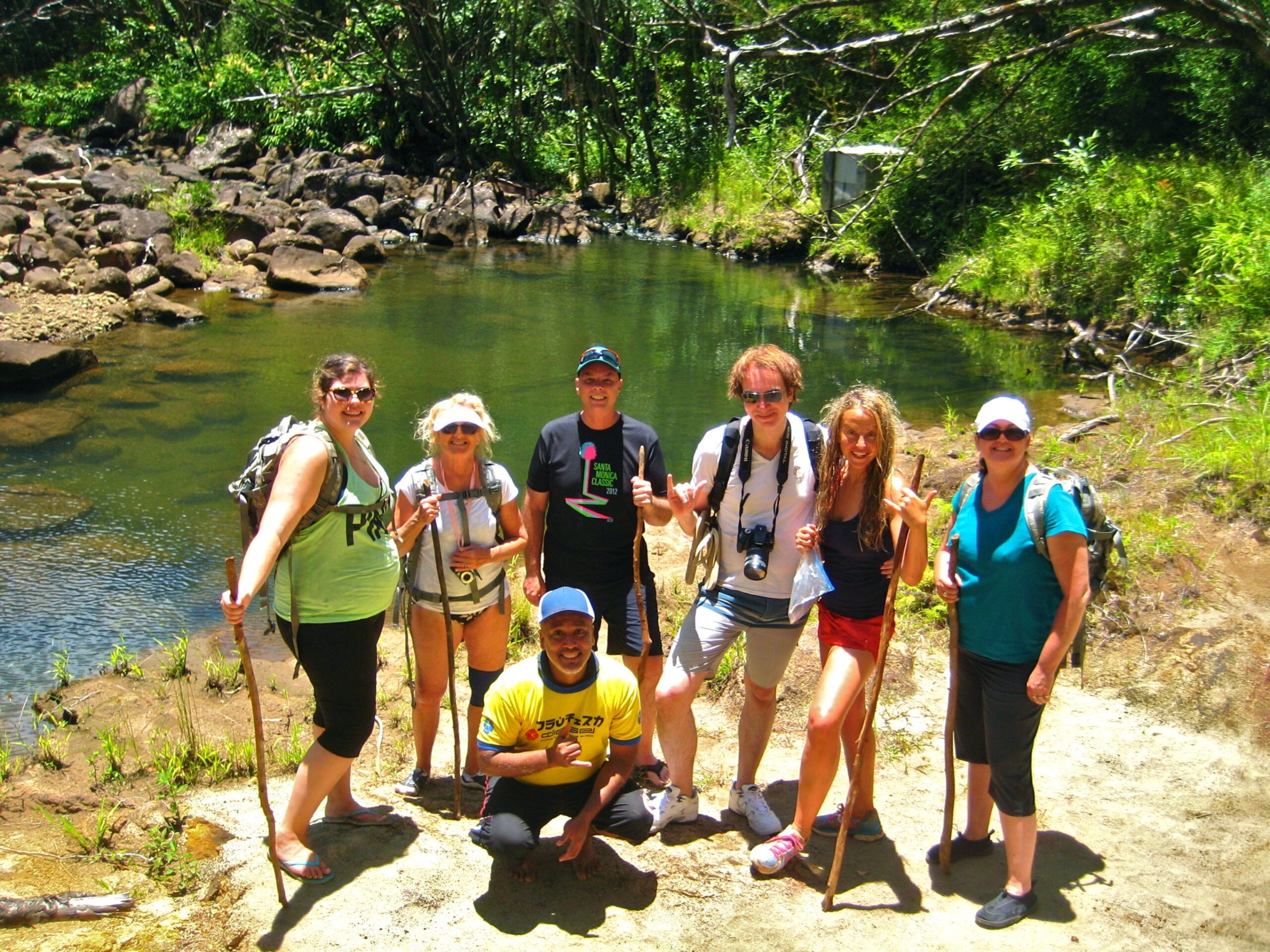 a group of people standing next to a river