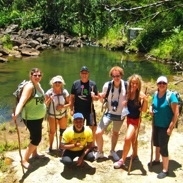 a group of people standing next to a river