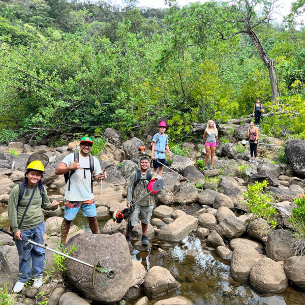 a group of people standing on a rock