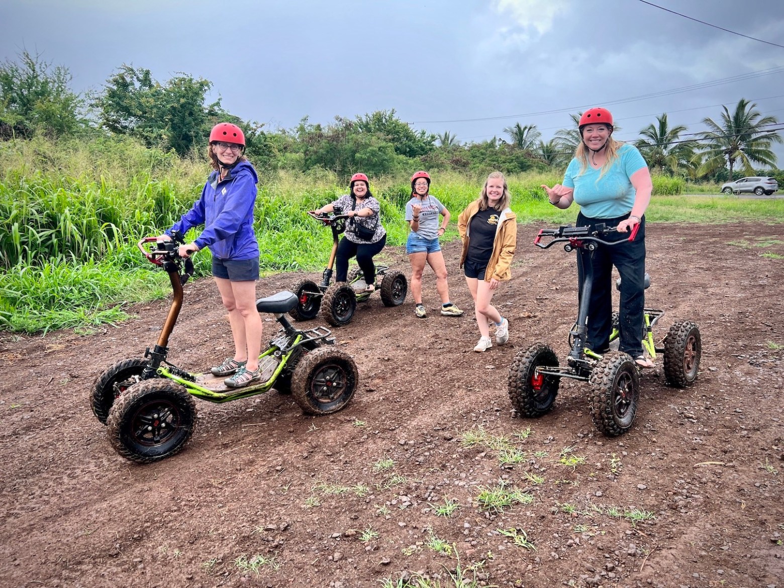 a group of people riding a motorcycle down a dirt road