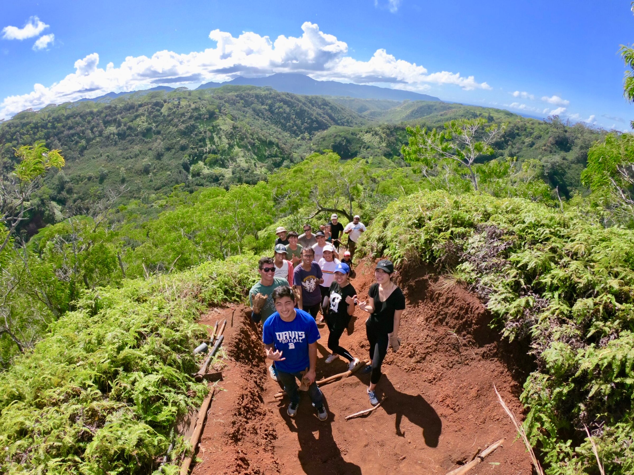 a man riding a bike down a dirt road