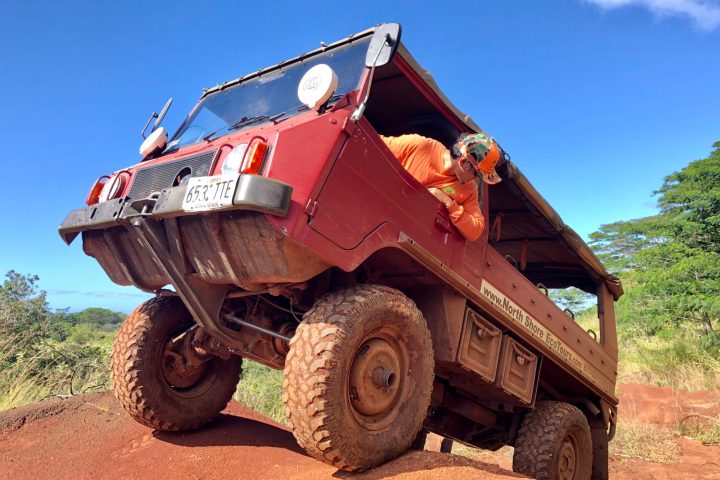 a truck driving down a dirt road