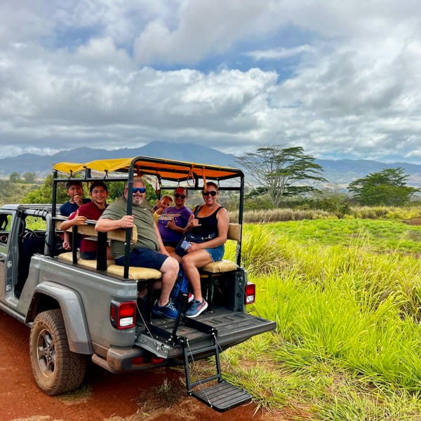 People riding in the back of a Jeep